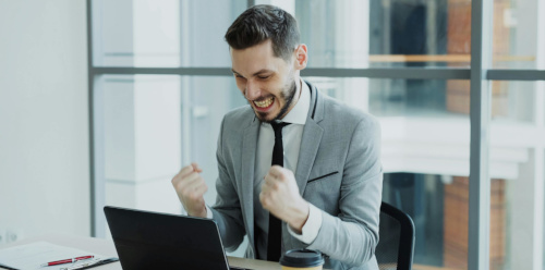a public domain picture of a man excited at a computer by Vitaly Gariev